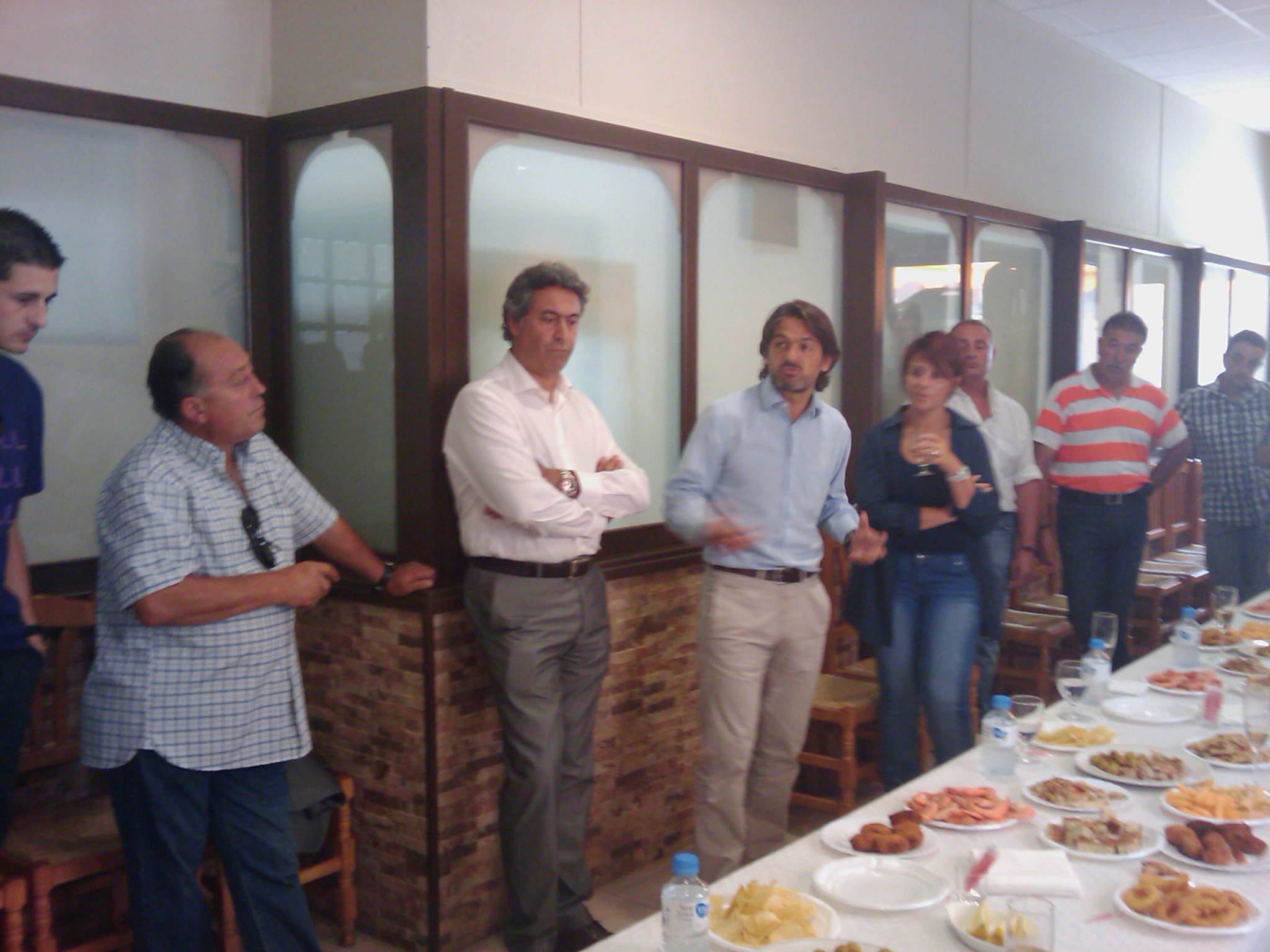 a group of people standing around a table