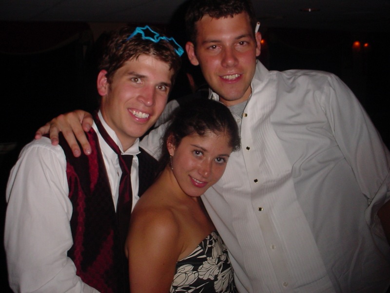 three young adults in dress clothes posing for a picture