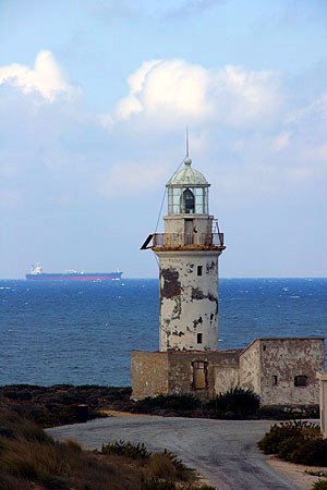 an old light house next to the ocean