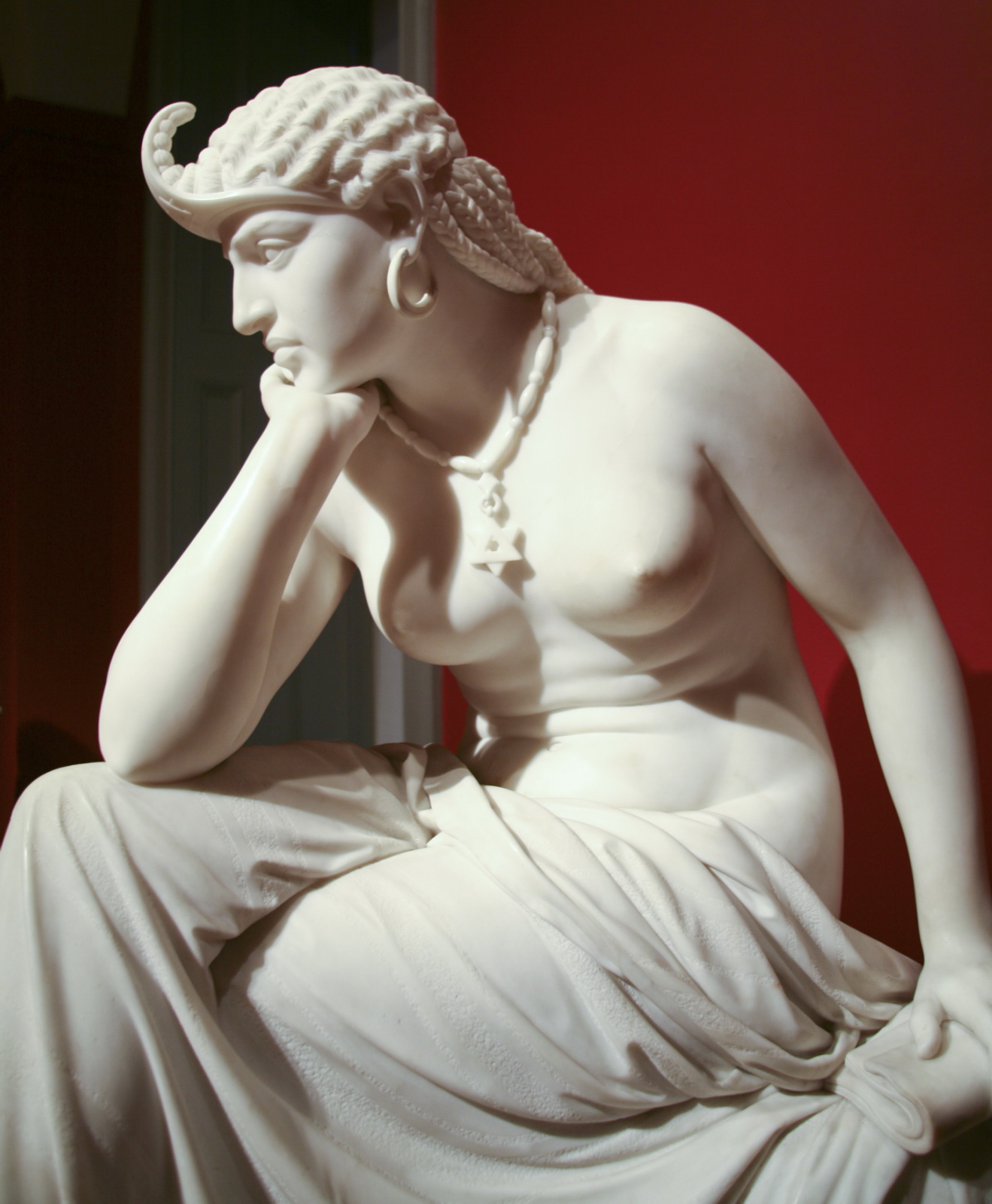 a statue with pearls on her head and white skin