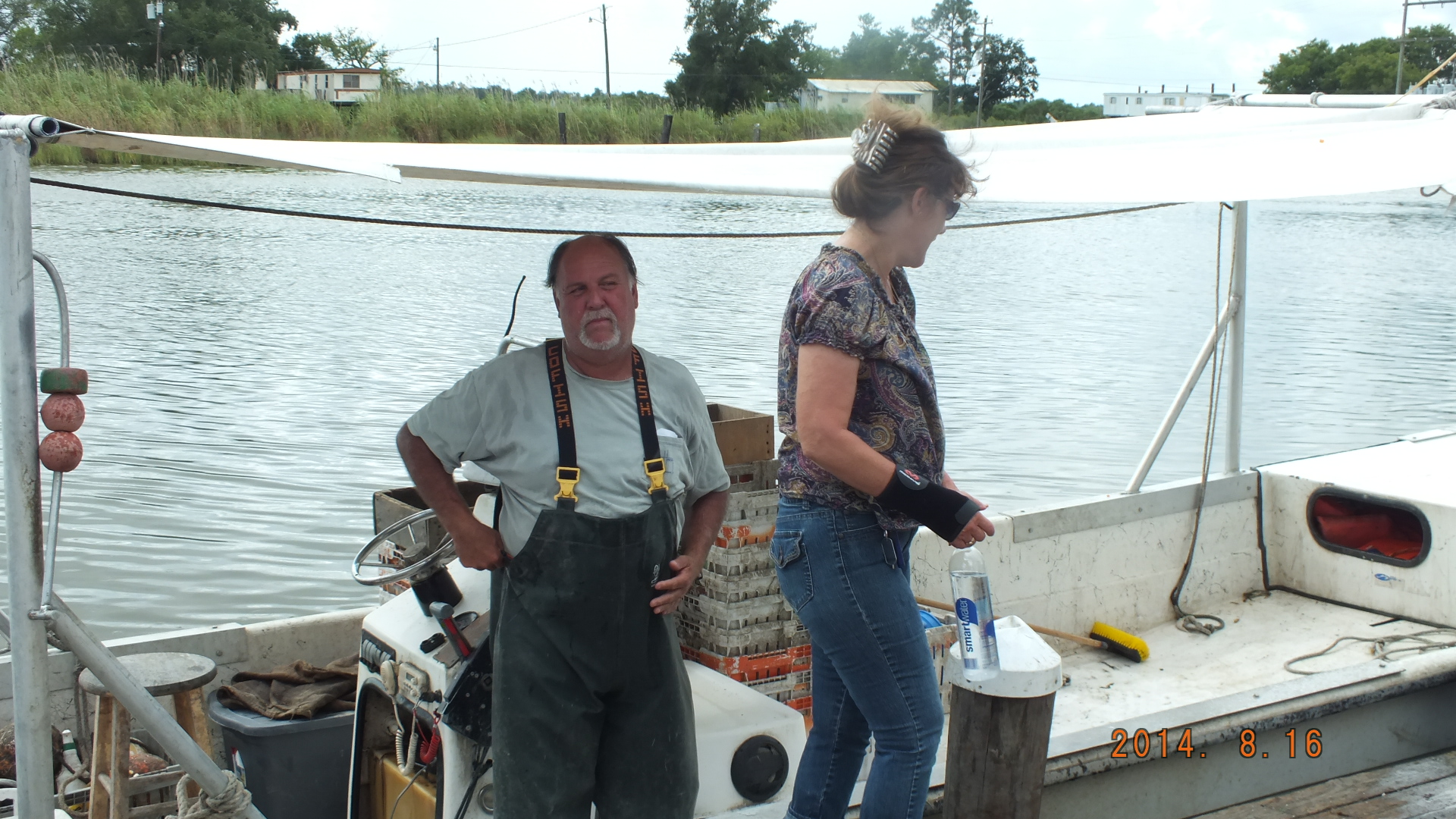 a couple of men standing on top of a boat