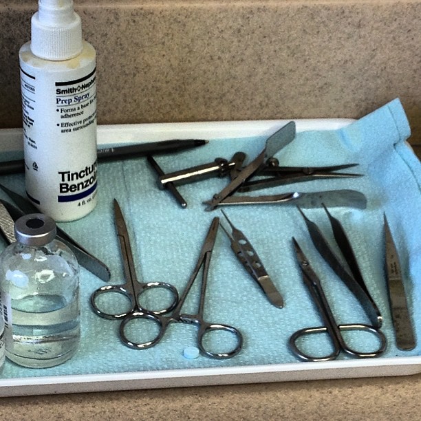 tools on a tray with some glass bottles