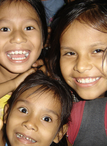 four girls smile while posing for the camera