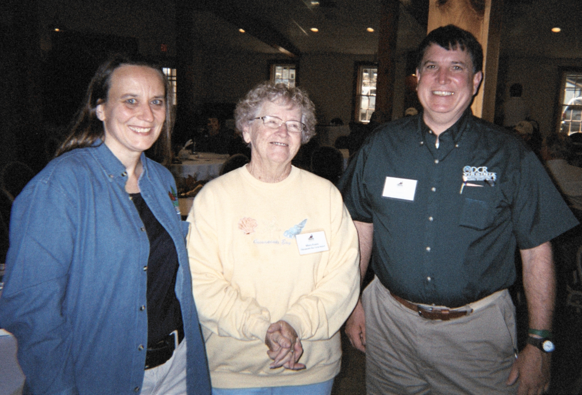 three women and one man smiling for the camera