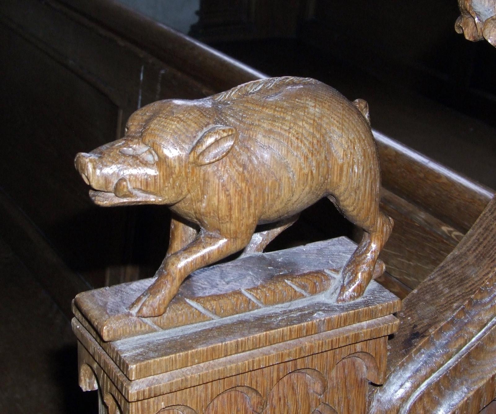the sculpture of a pig is made of wood