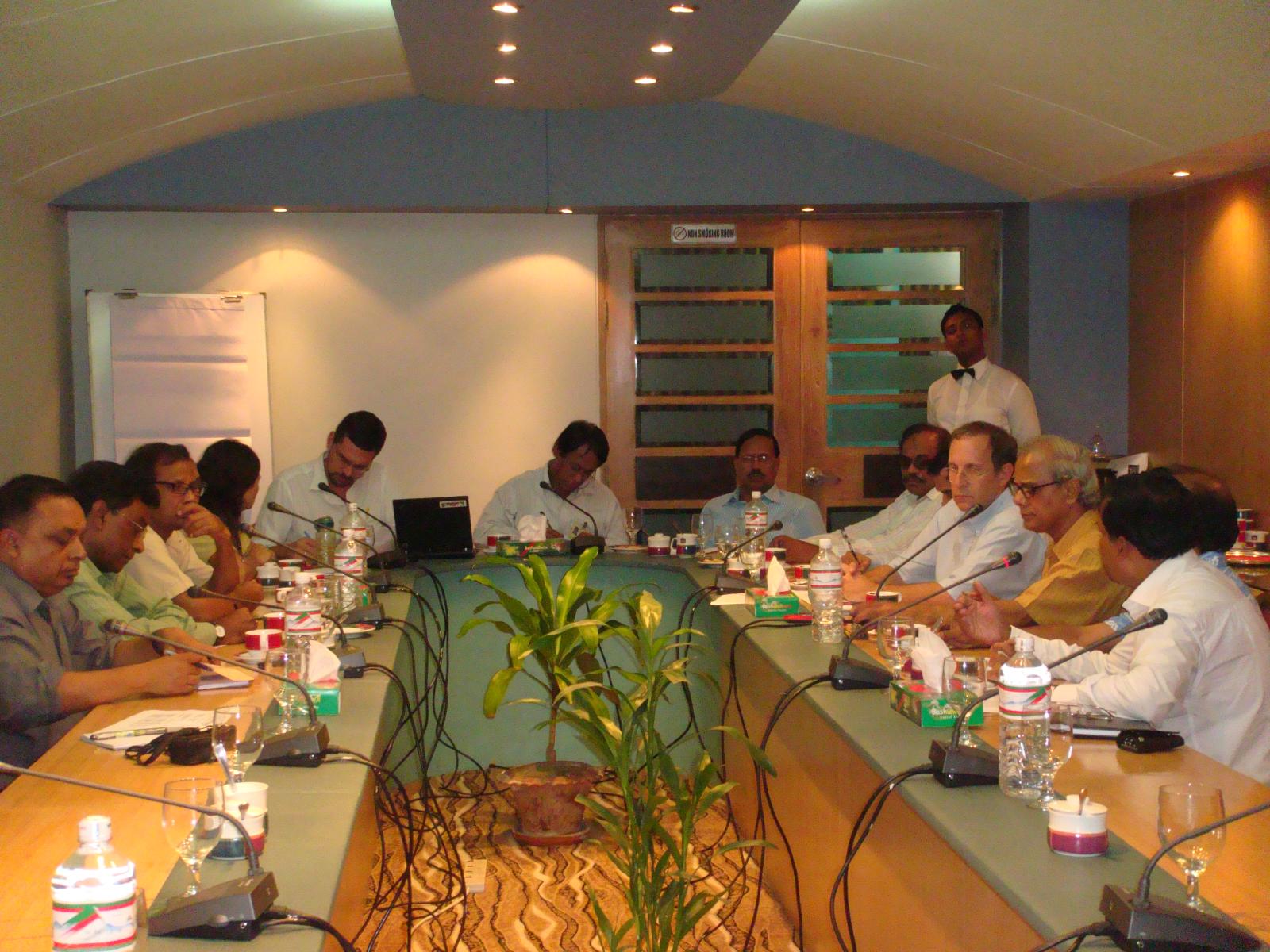 a group of people sitting around a table in a room