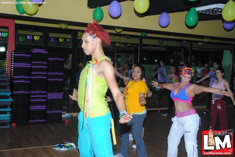 young adults standing around a dance floor with large mirror