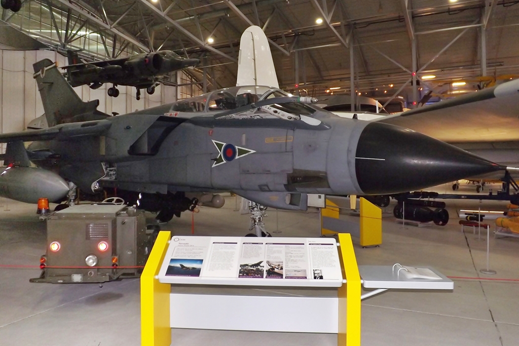 there is a fighter jet sitting on display in the museum