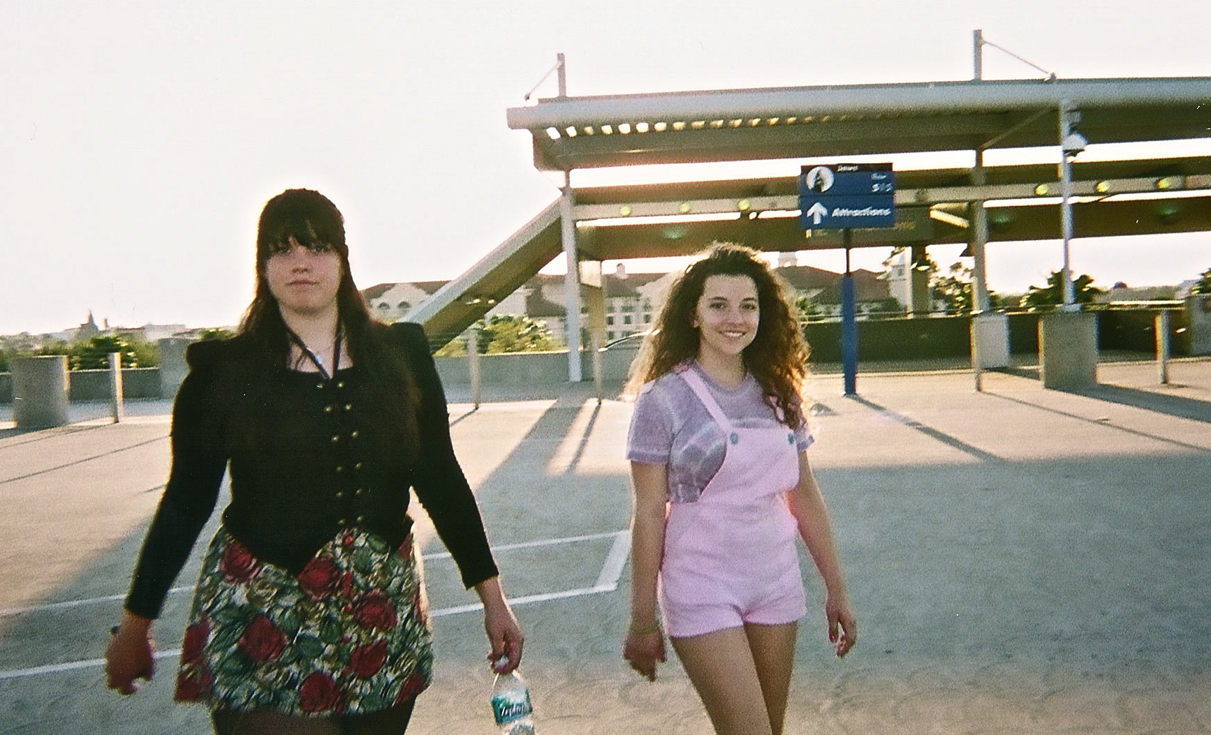 two women walking across the tarmac at an airport