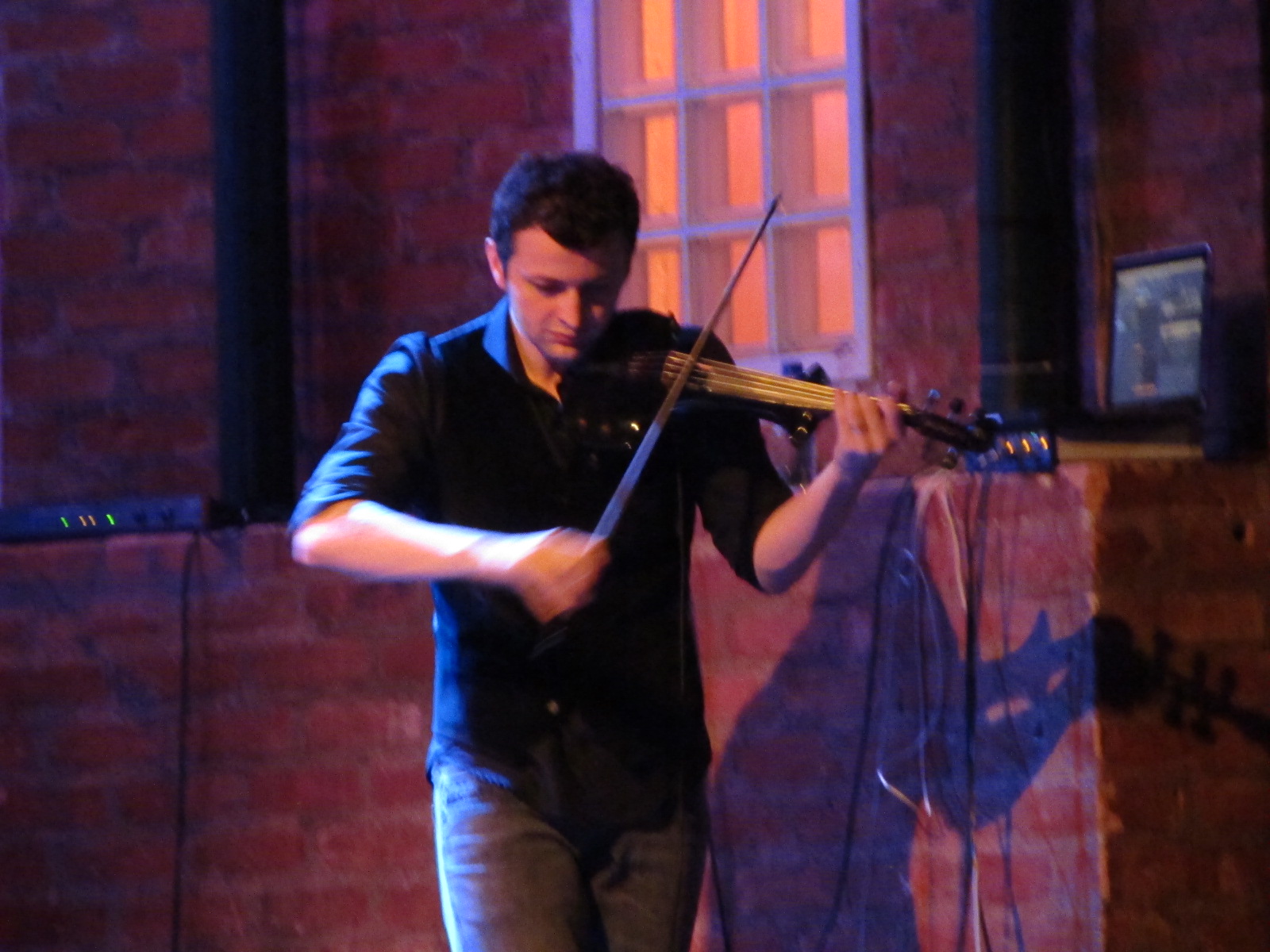 a man plays the violin and sings with an instrument