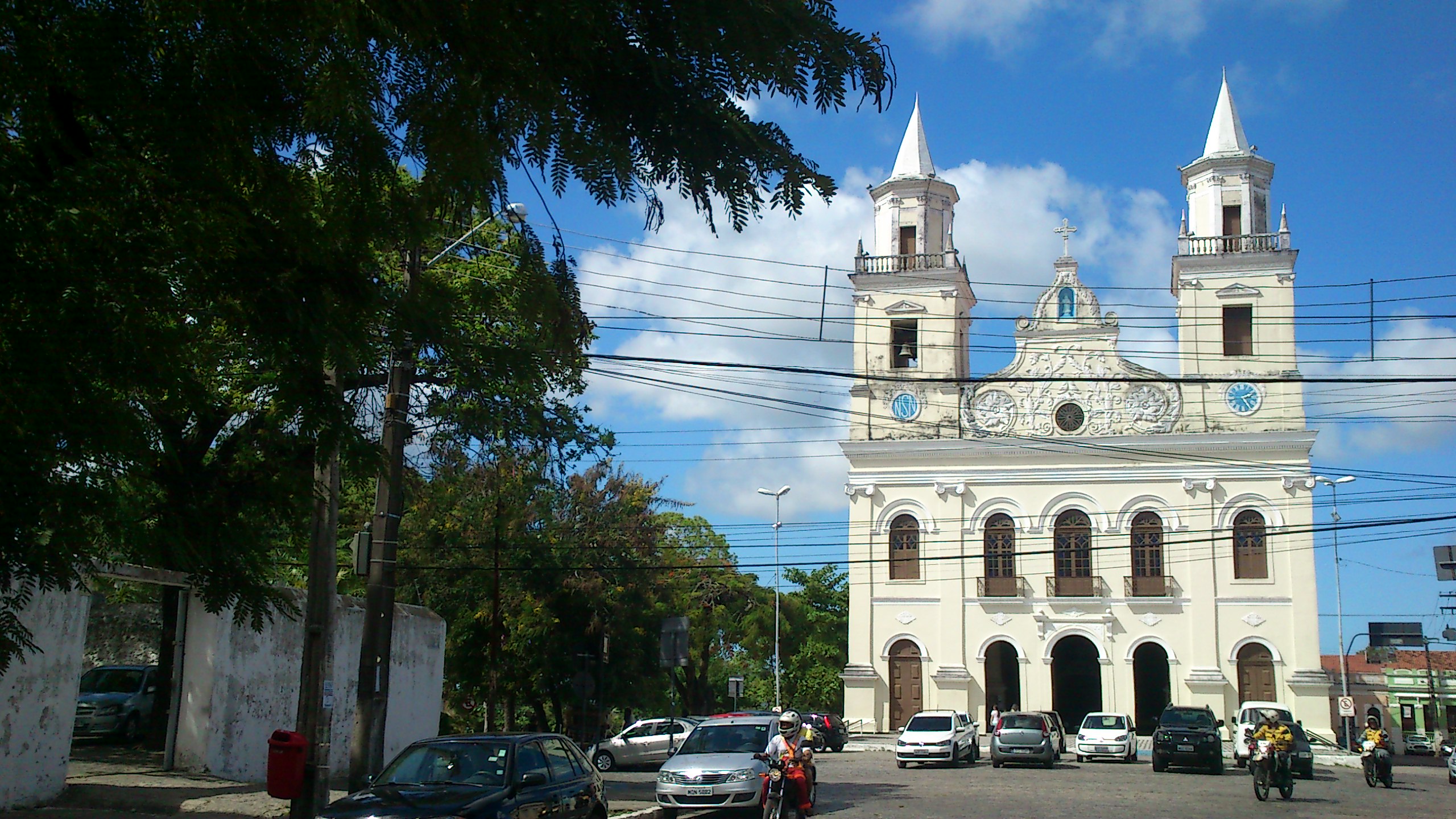 a church with white and brown architecture and two towers