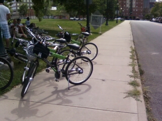 a row of bikes parked next to each other on a sidewalk