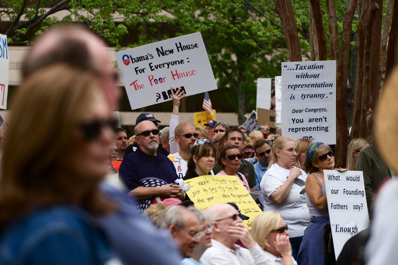 group of people in the street with signs and placards