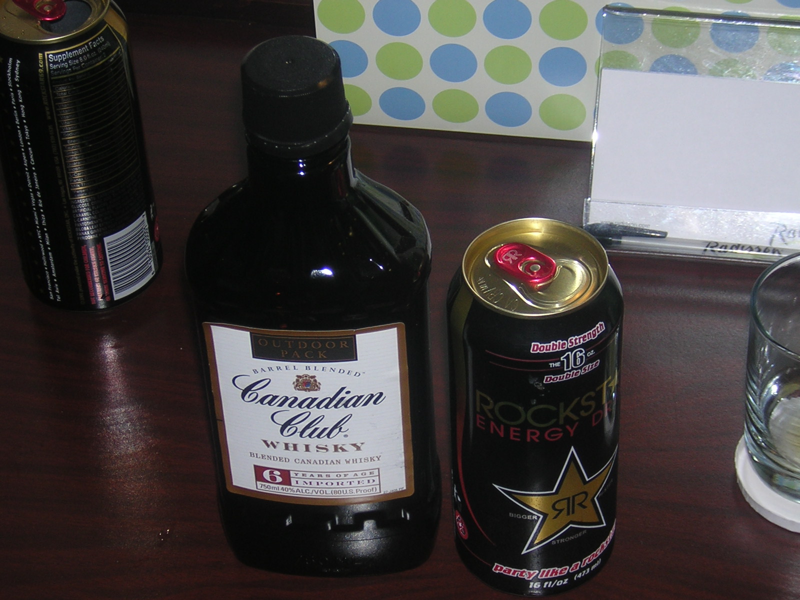 two bottles, one with a star on the side, sit on a table