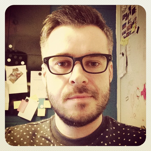 man in glasses and polka dot shirt looking at camera