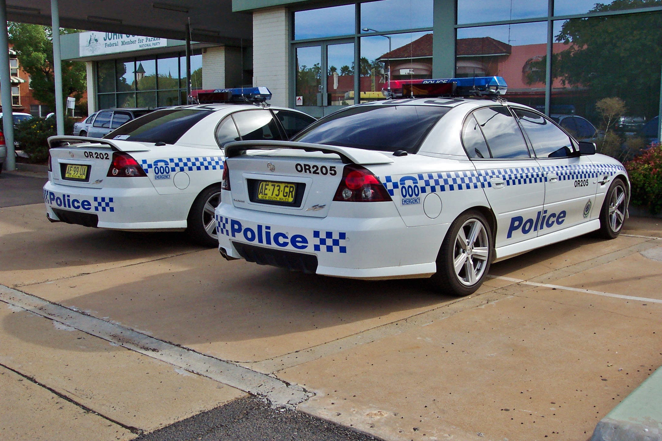 two police cars parked in front of a building