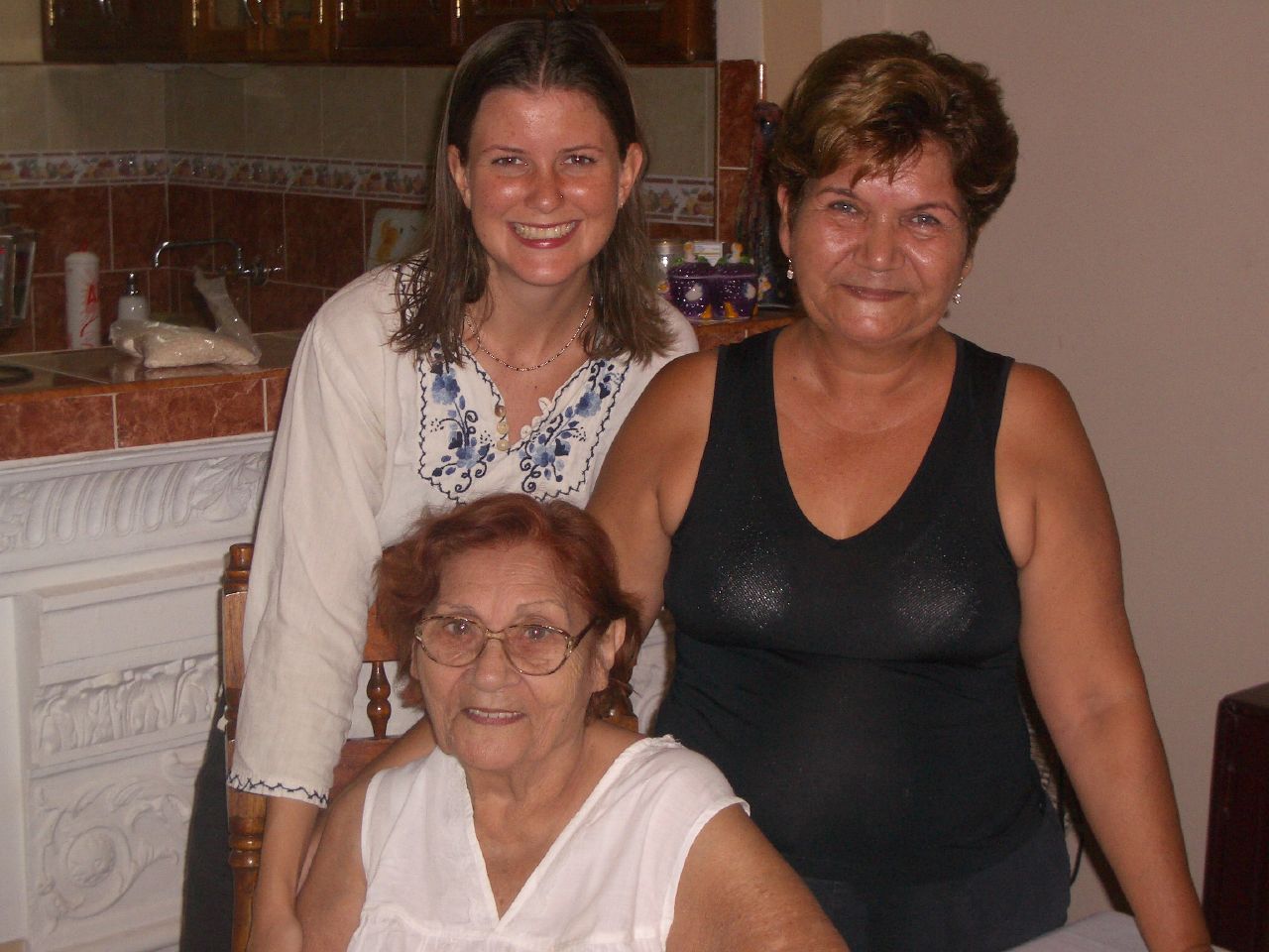 an older lady and two younger ladies sitting next to each other