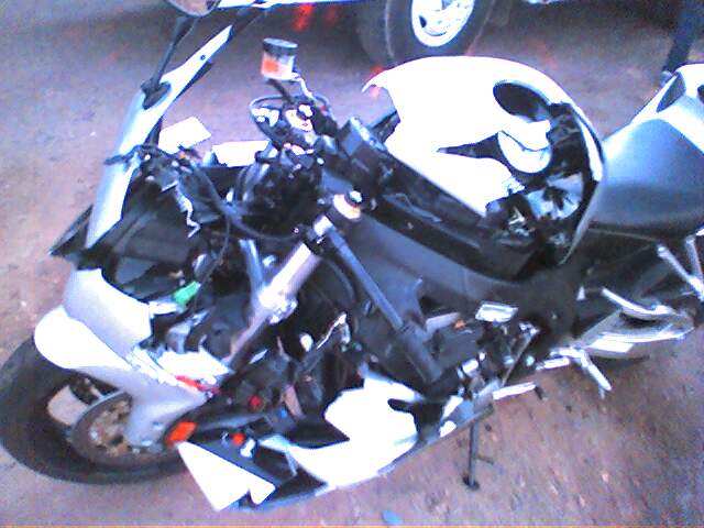 a white and black motor cycle parked next to other motor bikes