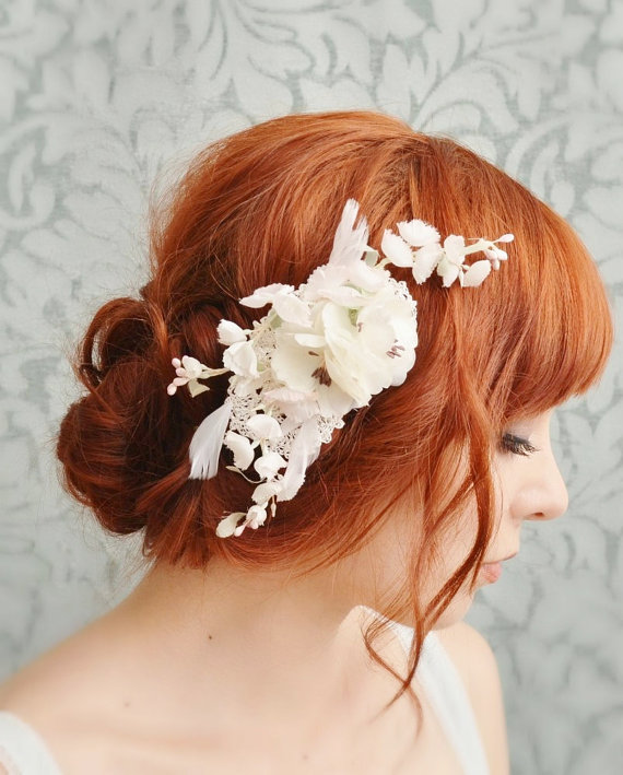 a young redhead woman has a hair flower in her hair