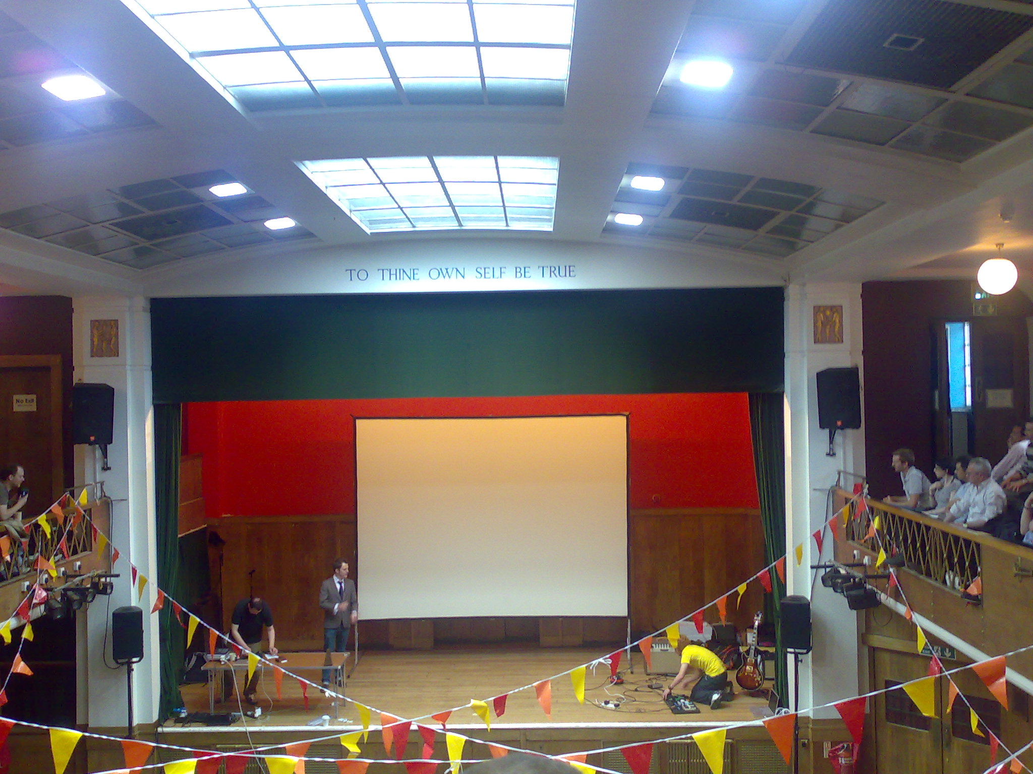 a theater with flags and curtains in the middle