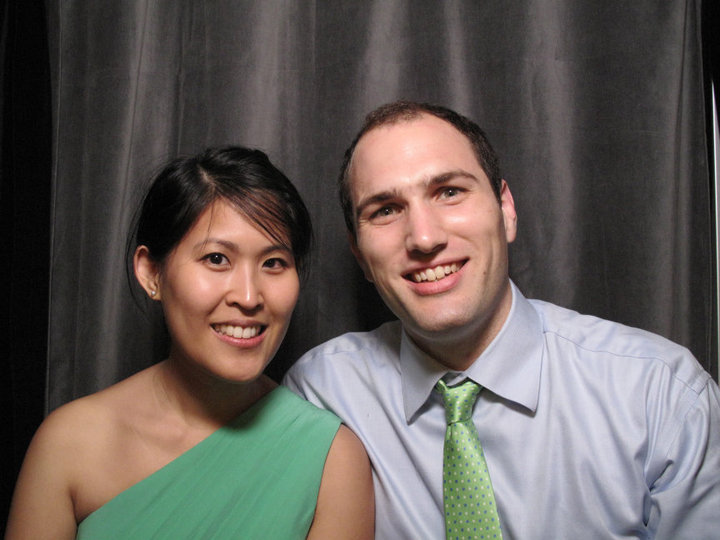 a woman with a green dress standing next to a man