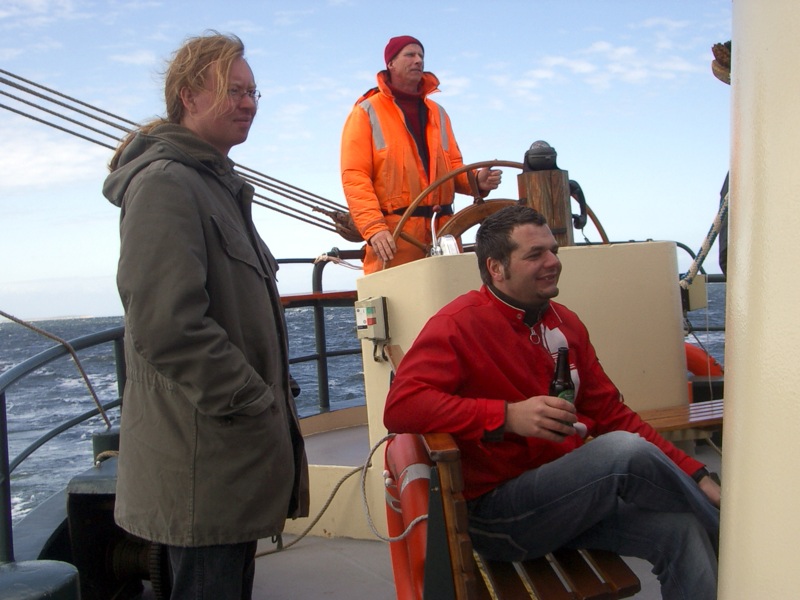 two people in an orange life jacket on a boat