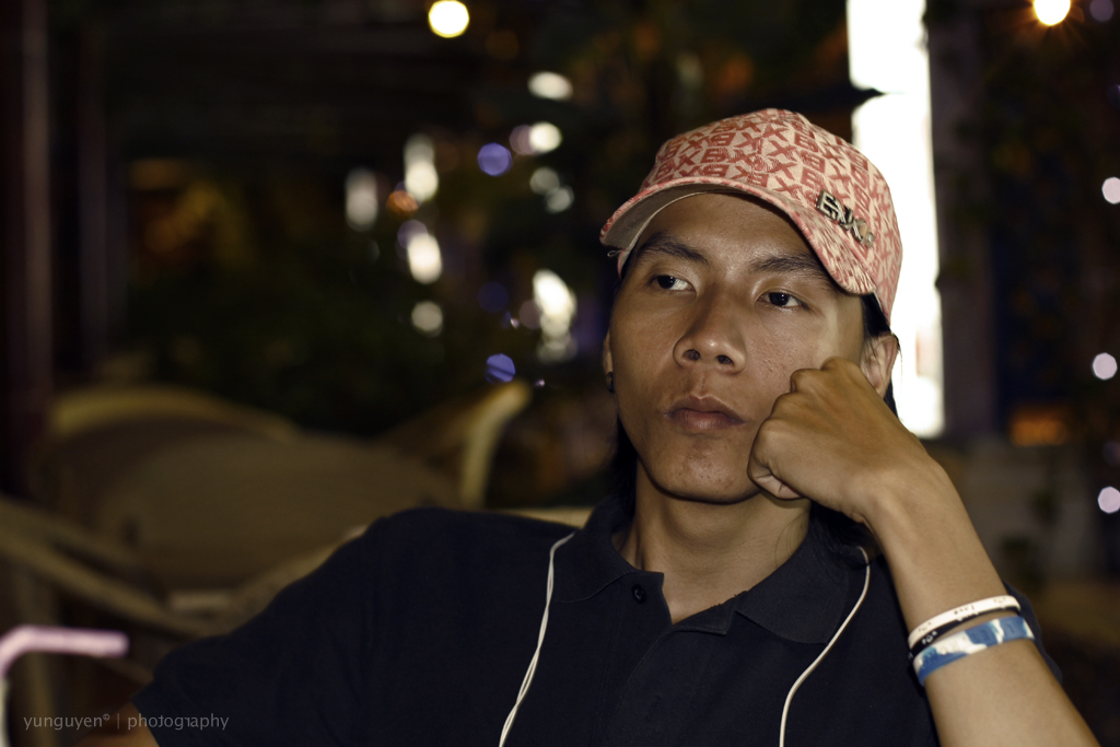 a man with a red hat and earbuds on