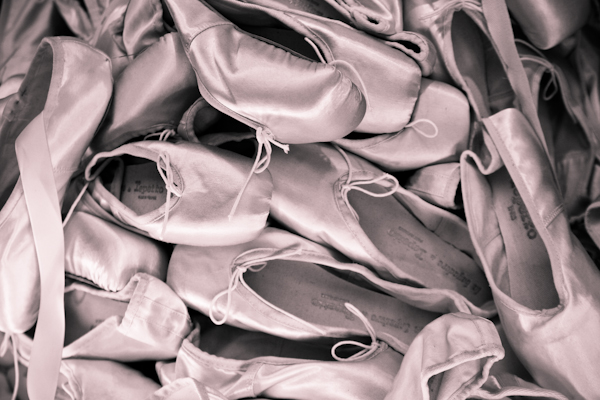 a close up of a pile of ballet shoes