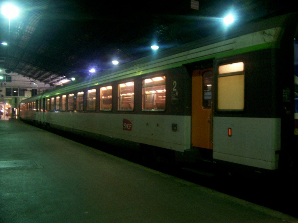 a train on a track near some lights