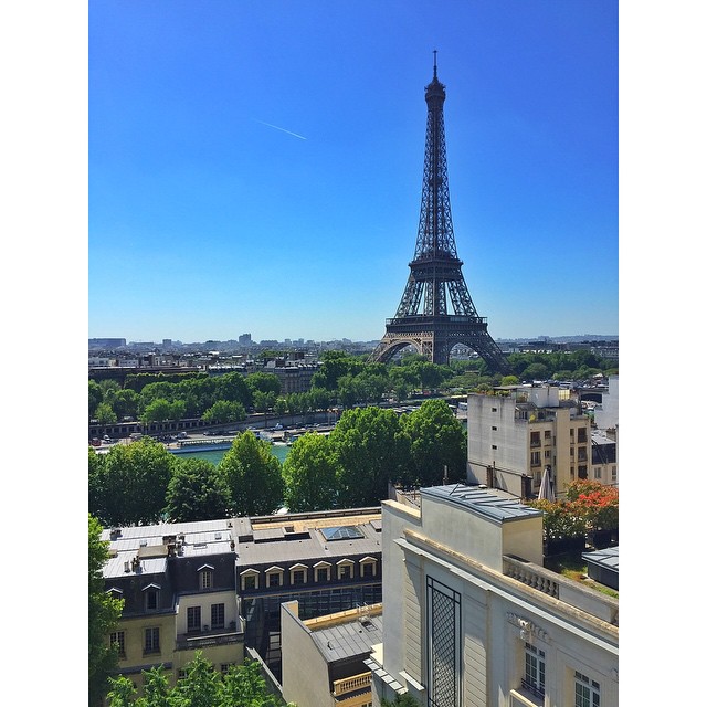 the eiffel tower as seen from behind a rooftop in paris