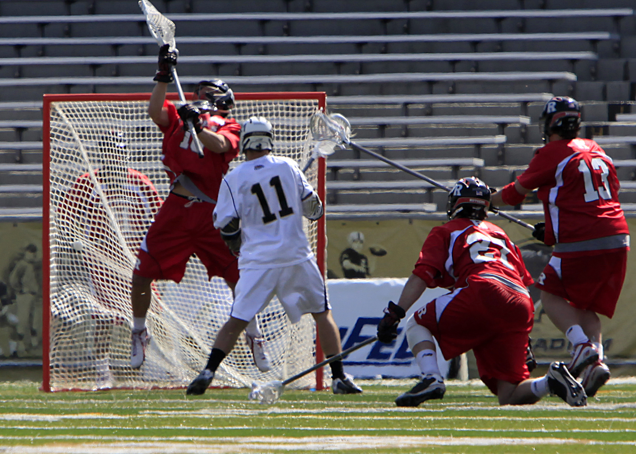a lacrosse game with the player holding the ball in his hands