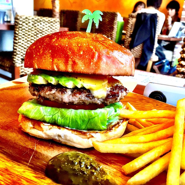 a large hamburger with lettuce on a table