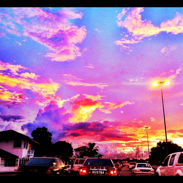 colorful sunset over parking lot with bright clouds