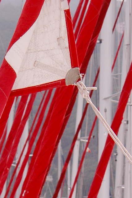 a large wind sail in the shape of a triangle on a pole