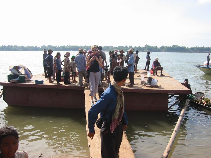 several people are at the water with boats on the shore