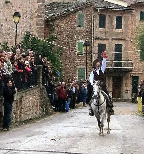 some people watching a man riding a horse