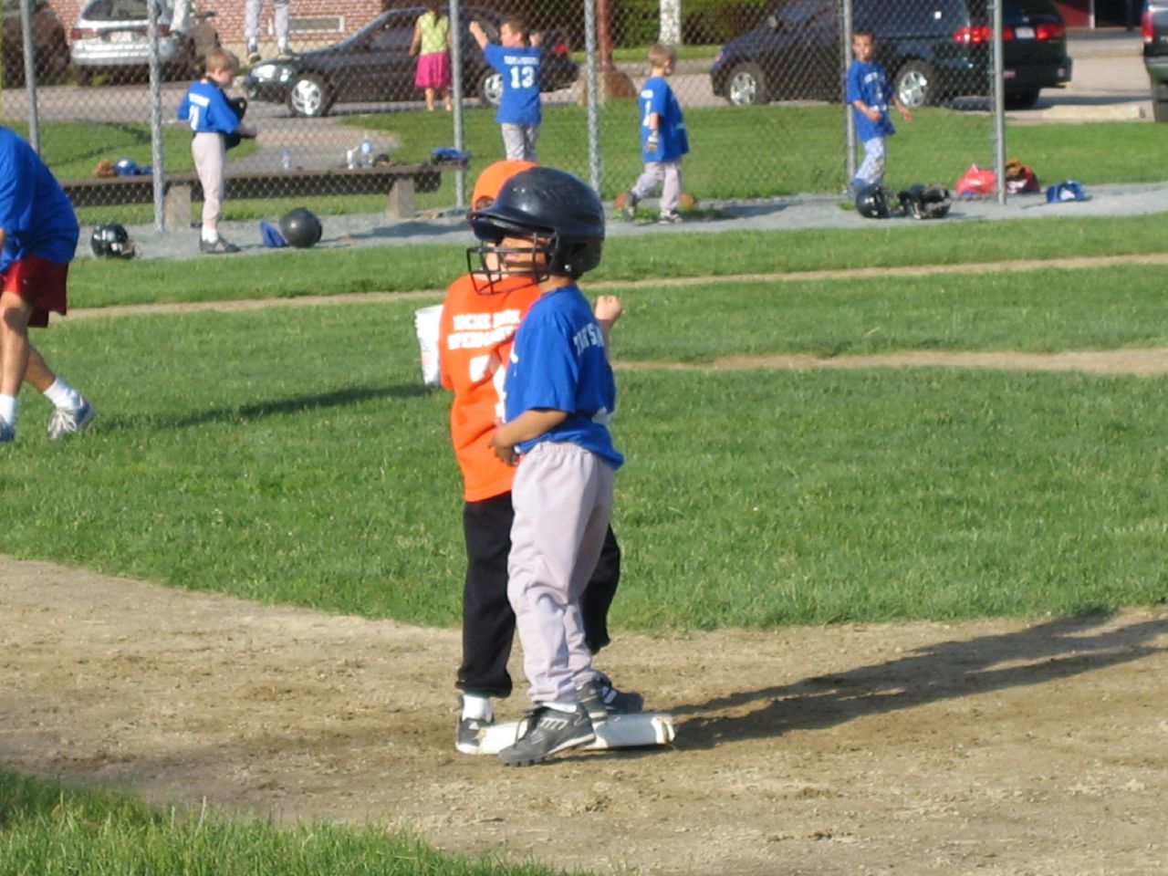 a little boy wearing a helmet and a catchers mitt