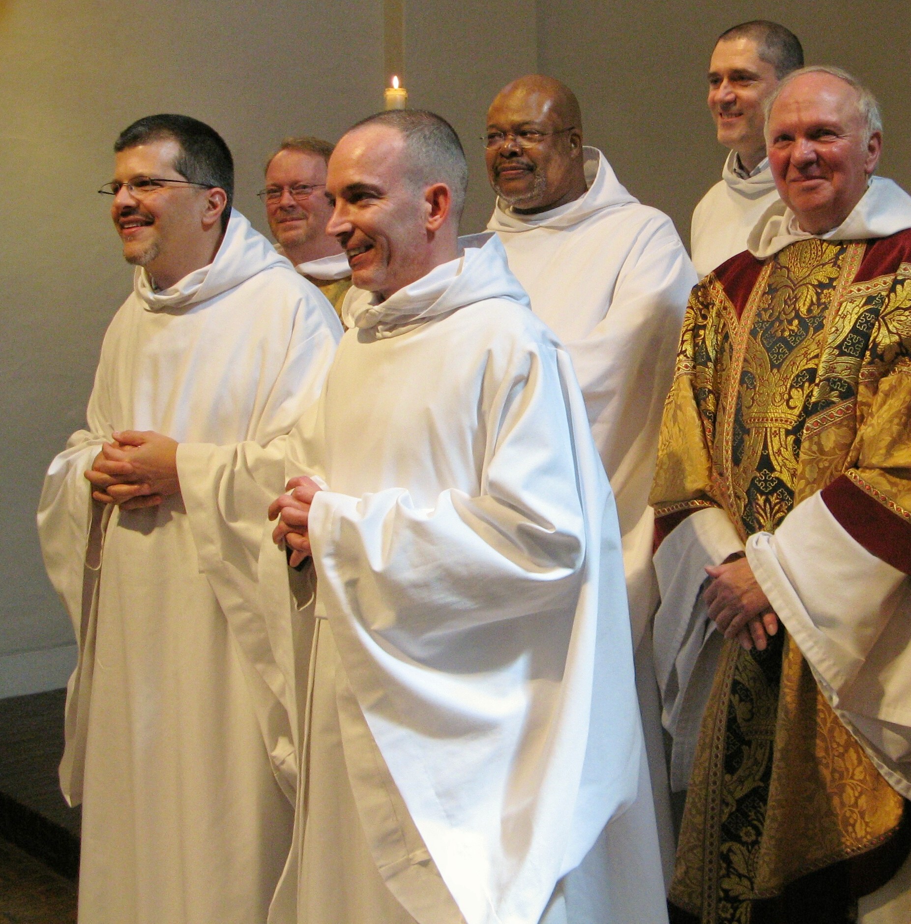 several men are standing together in white robes