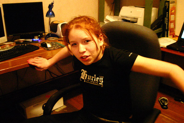 a young woman sitting in front of a computer