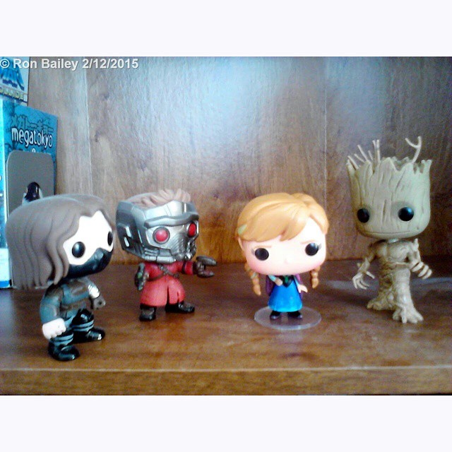 some pop figures are lined up on a shelf