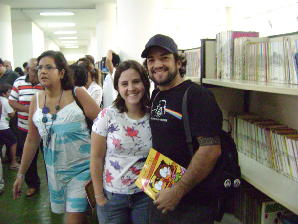 a young man and woman pose for a picture while smiling