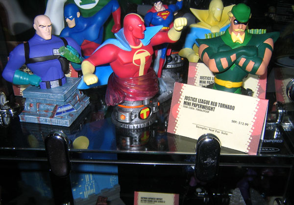 plastic superhero action figures sit on a counter