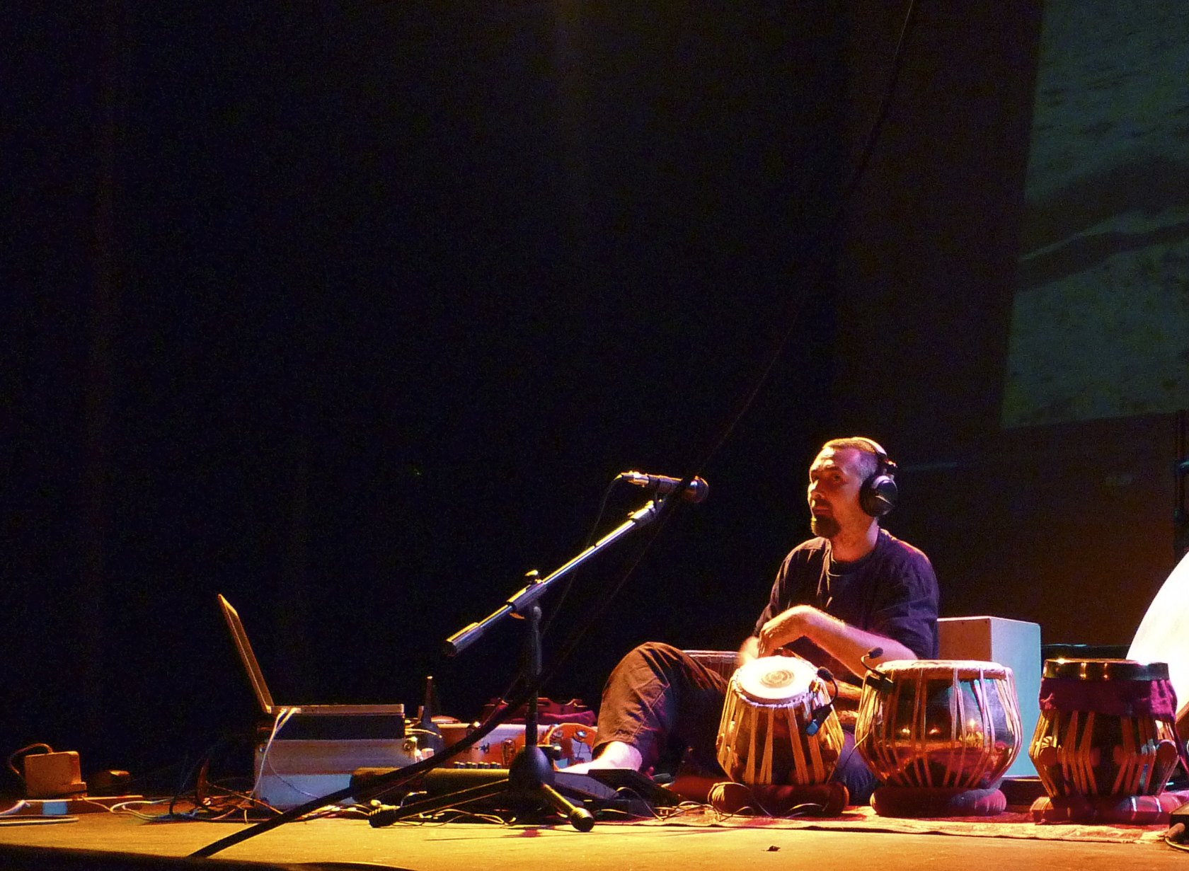 a man that is sitting in front of some kind of instrument