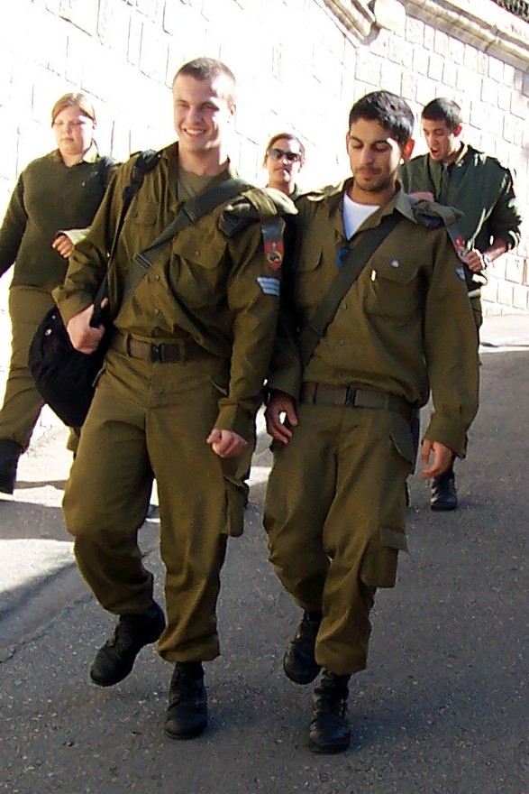 two guys dressed in military clothing are walking together
