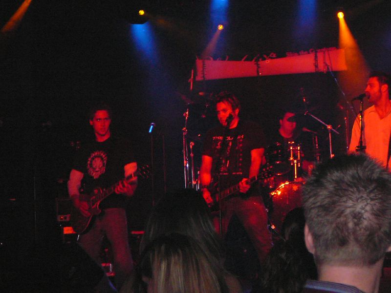 a group of men on stage playing guitars
