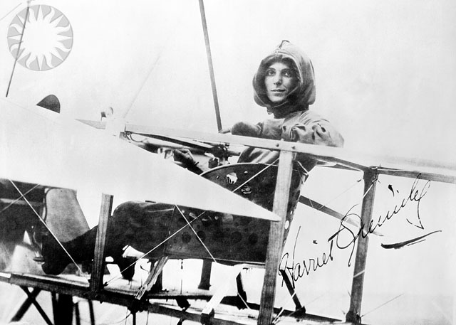 an old picture of a women in a plane