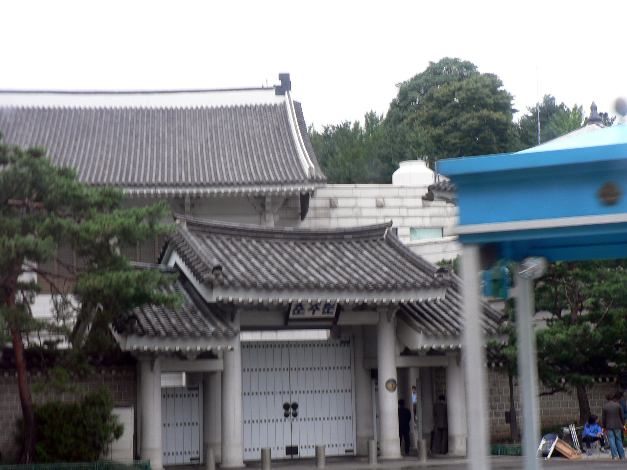 a view of the front of a white building with grey roof