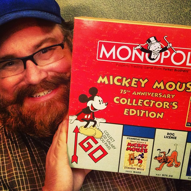 the man has a book with mickey mouse's color options