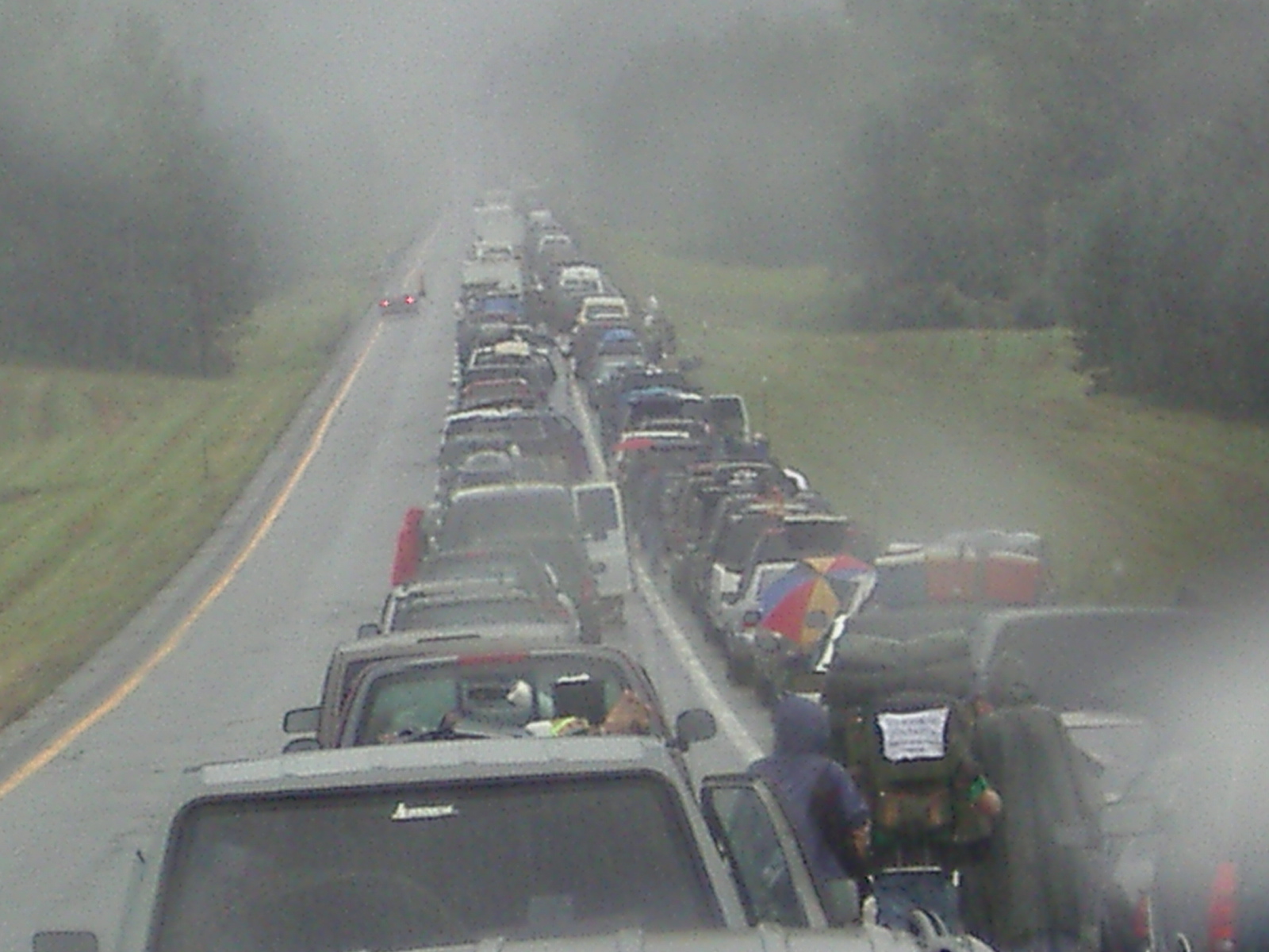 a line of cars that are parked on a road