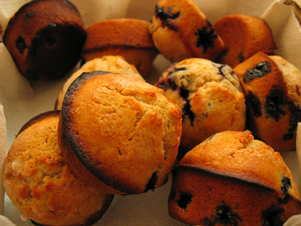 there is a basket full of muffins on the table